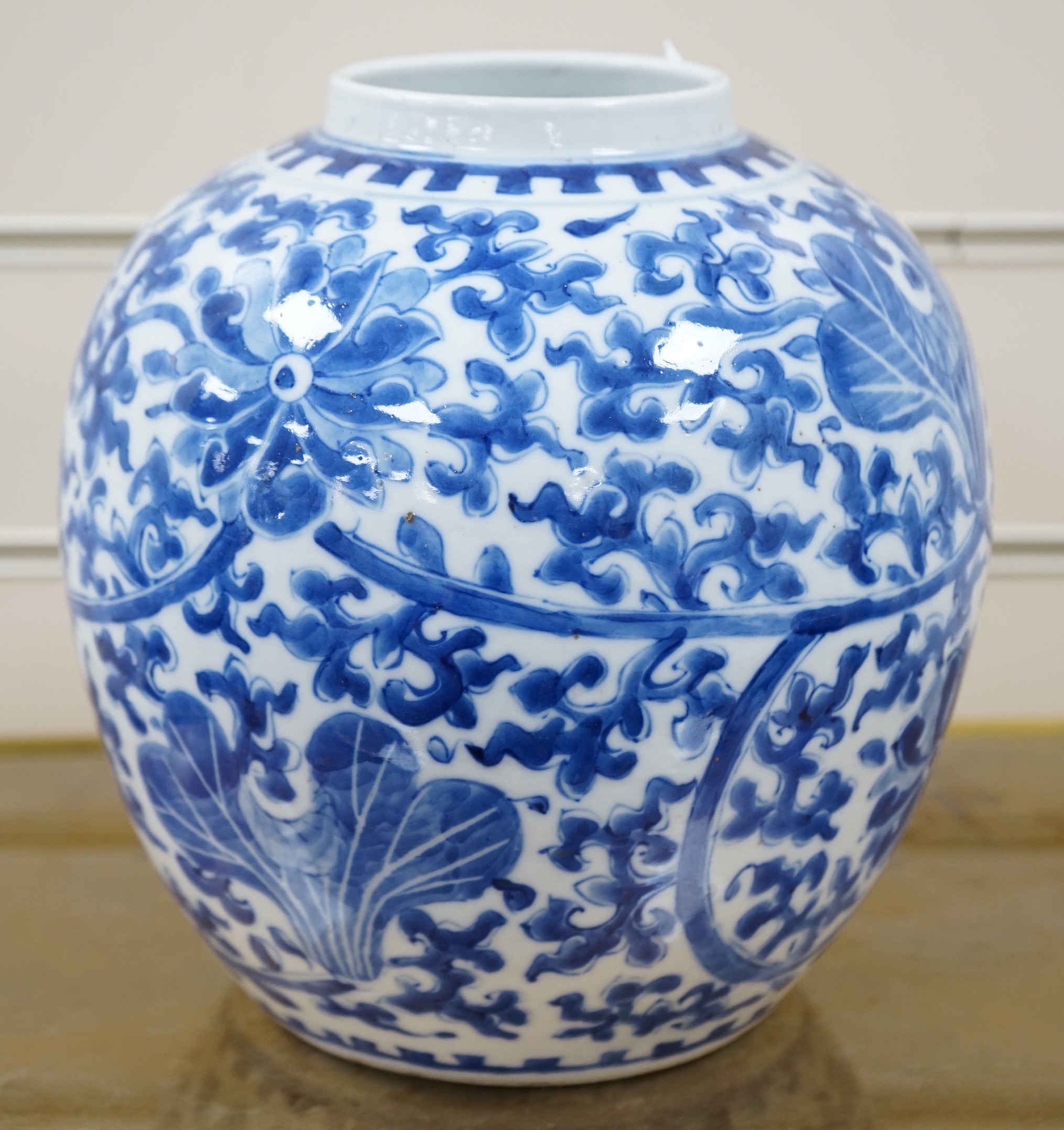 A late 19th century Chinese blue and white ovoid jar. 22cm tall, apocryphal Kangxi mark